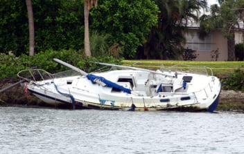 A boat capsized at a dock after a recent hurricane