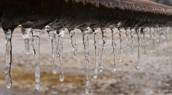 Icicles accumulate on the bottom of a pipe that burst from freezing, something that is easy to prevent.